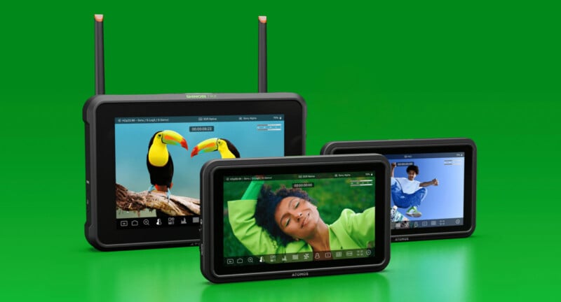 Three portable monitors with screens displaying vibrant images—a pair of toucans, a smiling person in green, and a person in blue clothing—are set against a bright green background. Two monitors have antennas.