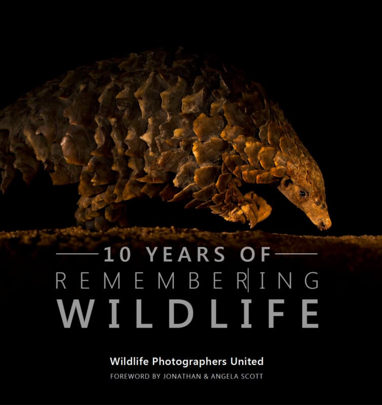 A pangolin on a dark background with text overlay: "10 Years of Remembering Wildlife." Below, it says "Wildlife Photographers United, Foreword by Jonathan & Angela Scott.