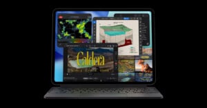 A tablet with an attached keyboard displays multiple overlapping app windows, showing weather maps, a 3D chart, video editing software, and images, highlighting multitasking capabilities on its screen.