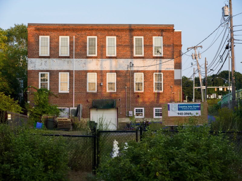 A three-story brick building with a sign for the Creative Arts Center.