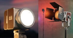 A split image shows two professional studio lights with a retro camera design: the left light shines brightly toward the viewer; the right light has its barn doors open, revealing an orange glow, both set against blurred colorful backgrounds.