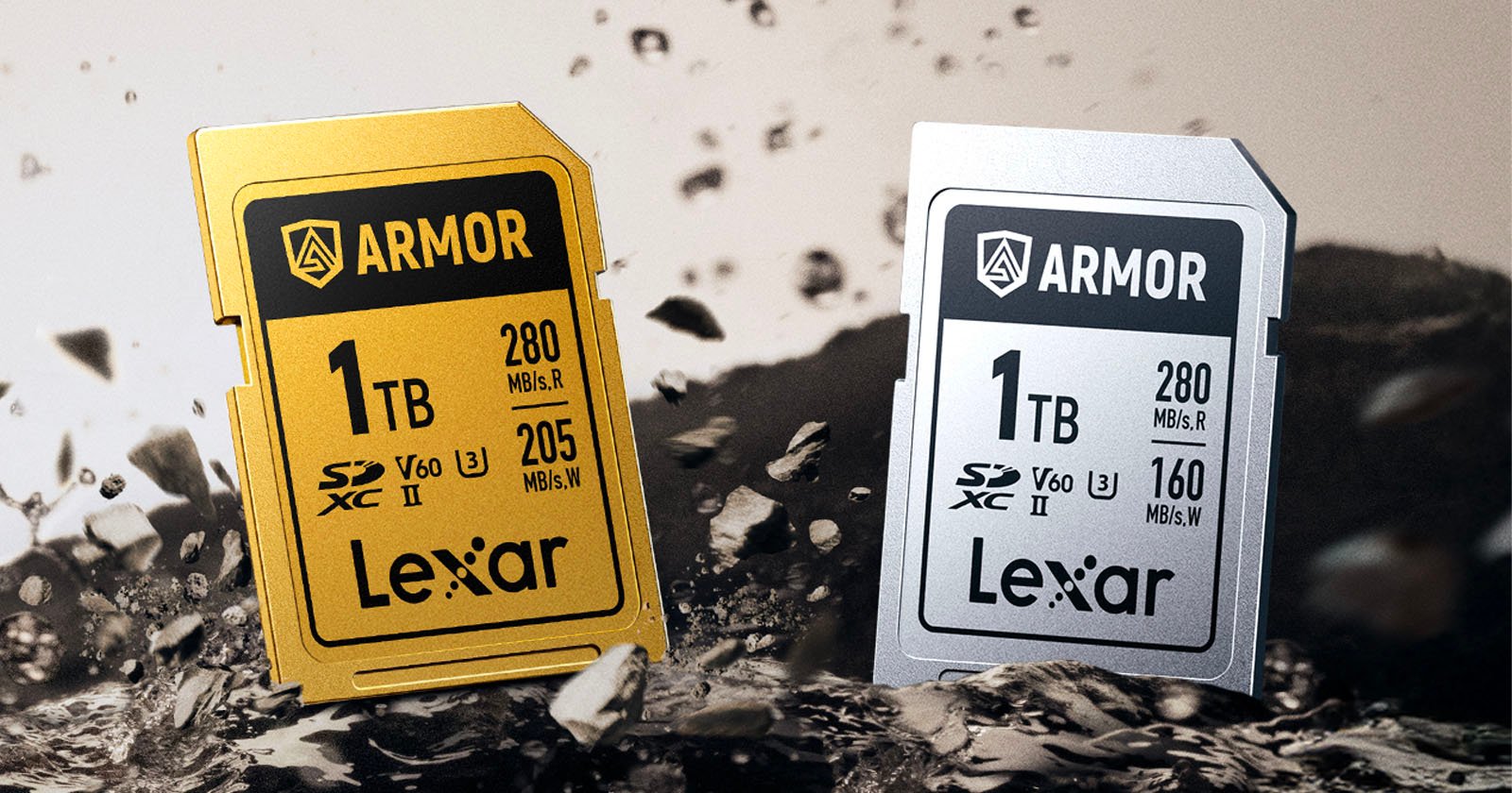 Two Lexar 1TB SD memory cards, one gold and one silver, are standing upright on a rocky surface with debris flying around them. Both cards are labeled "ARMOR" and display speed and capacity details on the front.