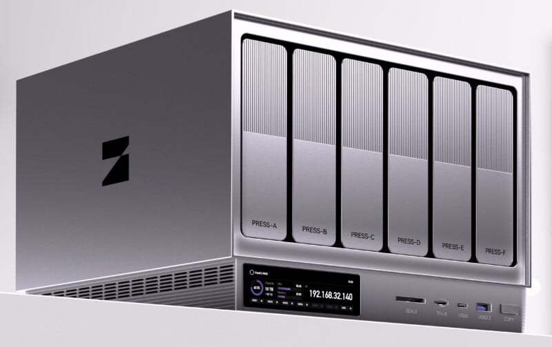 A metallic network storage device with six labeled drive bays (PRESS-A to PRESS-F), a display screen showing an IP address, and various ports on the front panel. The device has a modern, sleek design.