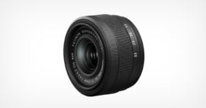 A Fujinon aspherical camera lens with a black, ribbed body, visible focus, and aperture rings, marked with various focal lengths and aperture values. The lens is positioned against a plain white background.