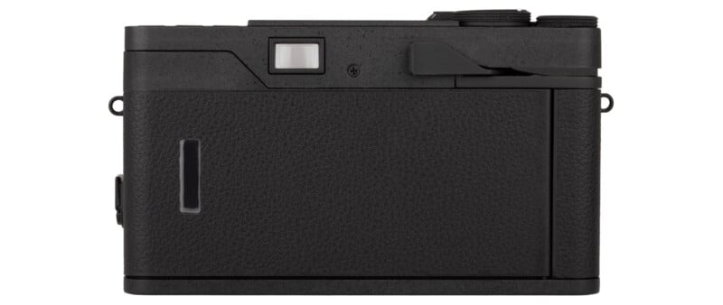 Back view of a black digital camera showing a textured surface, a small rectangular viewfinder, control dials on the top right, and no visible LCD screen or buttons.