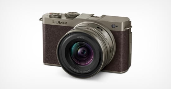 A Panasonic Lumix digital camera with a textured brown and metallic body, featuring a prominent lens and dials on top, displayed against a plain white background.
