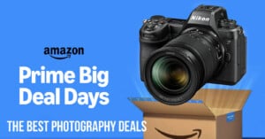 A Nikon camera hovers above an open Amazon box on a blue background. Text reads, "Amazon Prime Big Deal Days. The best photography deals.
