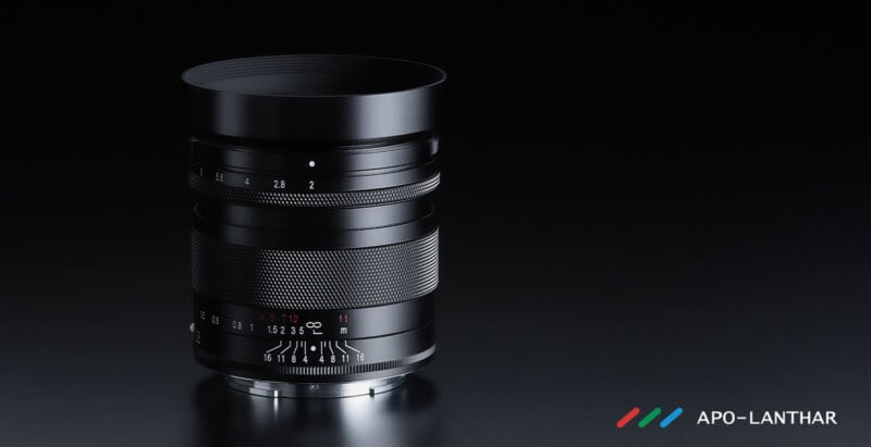 A black camera lens with textured focus and aperture rings sits on a dark reflective surface. The logo "APO-LANTHAR" with three colored lines appears in the bottom right corner.
