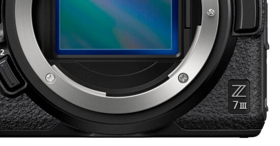 Close-up of a digital camera body showing the sensor, lens mount, and textured grip. The model name "Z 7II" is visible in the lower right corner.