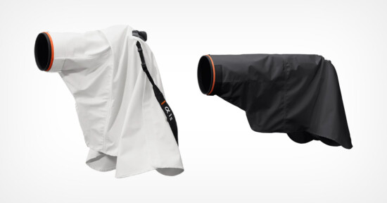 Two camera rain covers, one white and one black, are displayed side by side. Each cover has an orange-accented lens opening and is designed to protect cameras from rain or moisture.