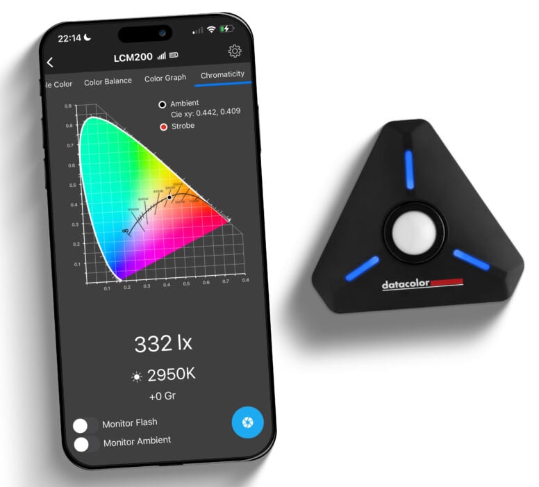 A smartphone displays a screen with a colorful chromaticity diagram and lighting measurements beside a triangular black device labeled "datacolor" with blue lights.