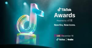 A colorful TikTok logo trophy is lit dramatically on the left. On the right, text reads: “TikTok Awards presented by e.l.f. New Era, New Icons. LIVE December 18 TikTok Tubi.”.