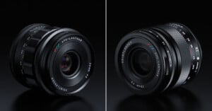 Side-by-side view of two Voigtländer APO-LANTHAR 28mm f/2 camera lenses on a black surface, showing different angles and the lens markings in white, red, blue, and green.