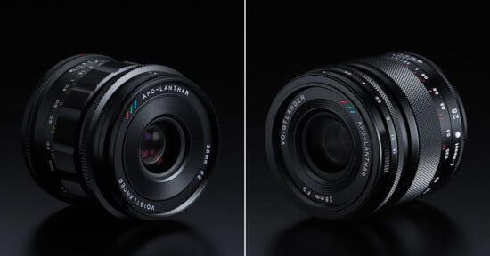 Side-by-side view of two Voigtländer APO-LANTHAR 28mm f/2 camera lenses on a black surface, showing different angles and the lens markings in white, red, blue, and green.