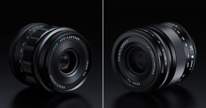 Side-by-side view of two Voigtländer APO-LANTHAR 28mm f/2 camera lenses on a black surface, showing different angles and the lens markings in white, red, blue, and green.