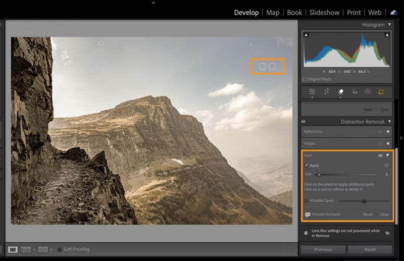 A computer screen displays Adobe Lightroom in Develop mode, showing a photo of a rocky mountain landscape. The Dust Removal tool is active, highlighting dust spots in the sky with circles and tool options on the right panel.
