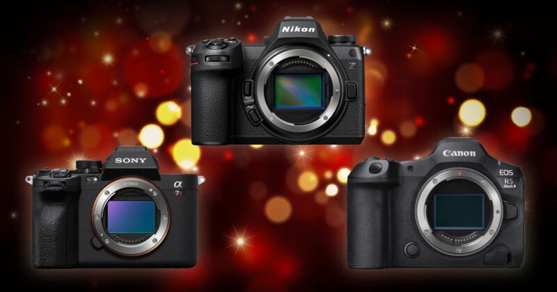 Tres cámaras digitales sin espejo (Sony, Nikon y Canon) se muestran sobre un fondo borroso de festivas luces rojas y amarillas. La montura de la lente y el sensor de cada cámara son visibles.