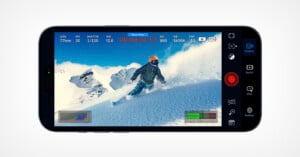 A smartphone screen displays a camera app interface capturing a skier in mid-action on a snowy mountain slope, with camera settings and recording details visible around the image.