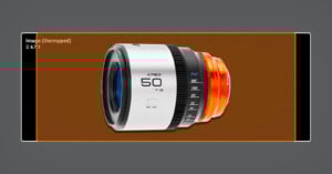 A white and orange camera lens marked "APEX 50 T1.8" is displayed in the center of a brown rectangular frame on a gray background with measurement markings and interface graphics.