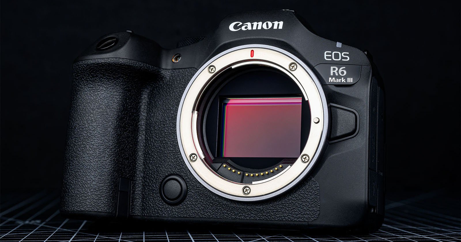 A Canon EOS R6 Mark III mirrorless camera body without a lens attached, showing the camera sensor and part of the lens mount, against a dark background.