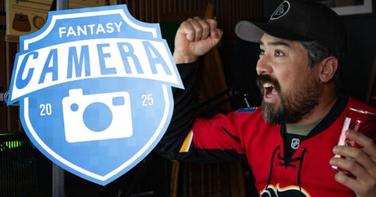 A man in a red hockey jersey and black cap cheers excitedly while holding a can of Coca-Cola. A blue "Fantasy Camera 2025" logo with a camera icon is overlaid on the left side of the image.