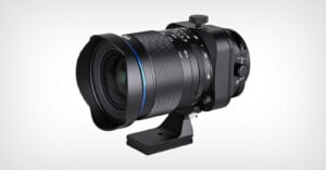 A wide-angle camera lens with a large front element, black metal body, blue accent ring, multiple adjustment dials, and a tripod mounting bracket, set against a plain white background.