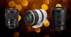 Three camera lenses are displayed side by side against a background of golden, circular bokeh lights. The lenses are of different sizes and brands, each shown at a slight angle to highlight their features.