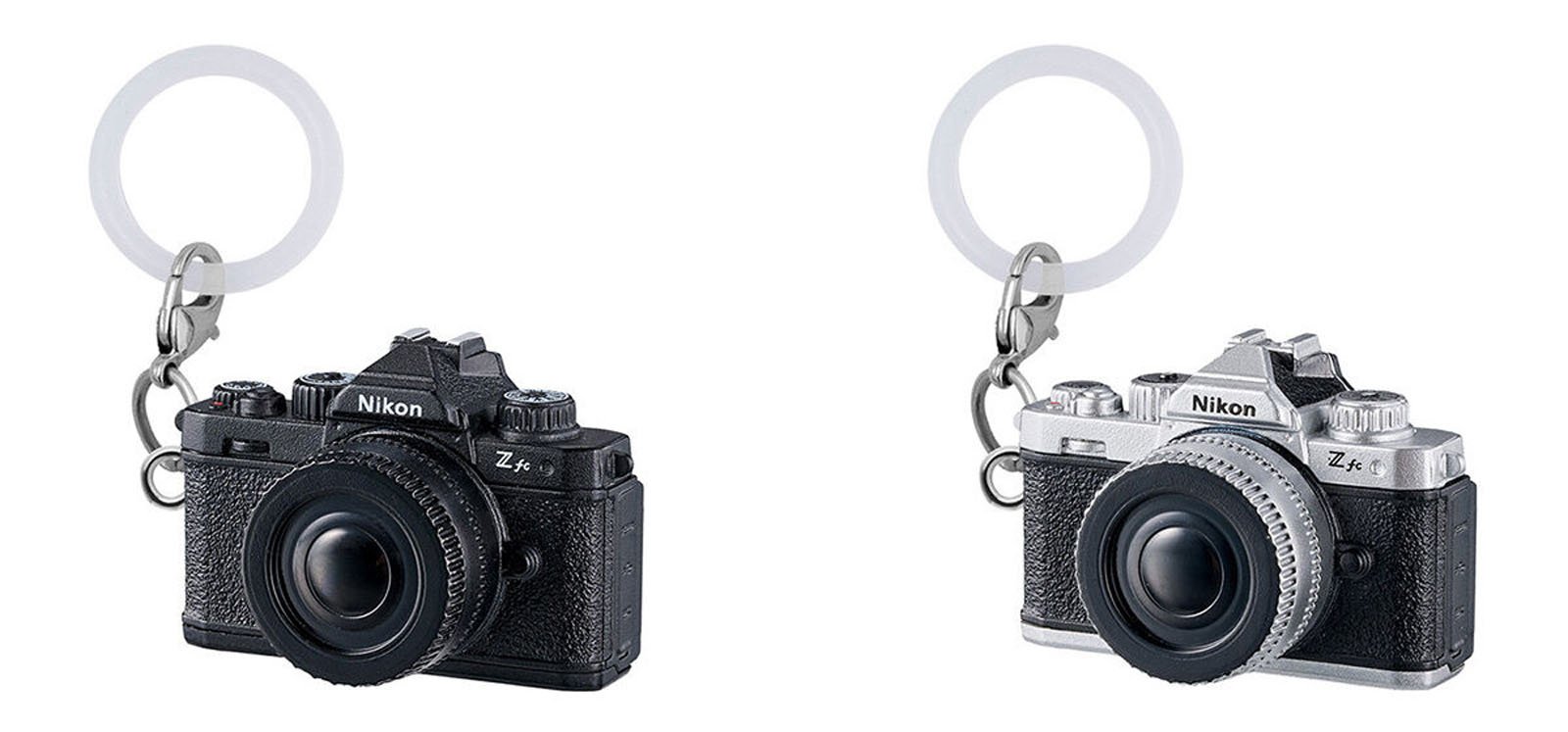 Two Nikon Z fc camera keychains, one in black and one in silver, with realistic camera details and attached silver key rings, displayed on a white background.
