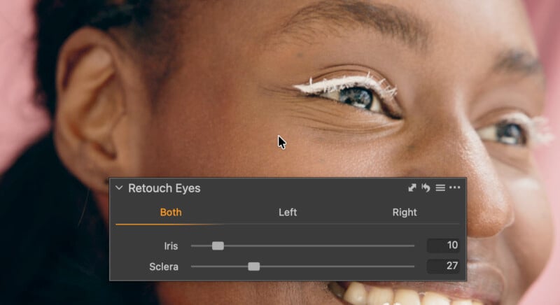 A close-up of a smiling woman’s face with white cosmetic lines above her eyelid. An on-screen menu labeled "Retouch Eyes" shows sliders for adjusting the iris and sclera values.