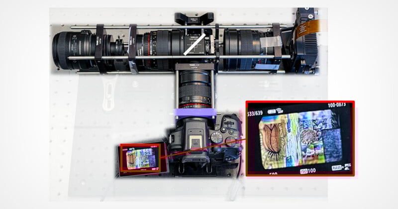 Overhead view of a digital camera attached to a rig with multiple lenses. The camera’s screen displays a detailed close-up of colorful objects, highlighted by a red box and zoomed in another box for detail.