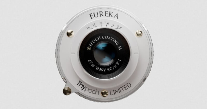 A close-up of a vintage-style camera lens labeled "EUREKA" with aperture markings, "Epoch Coating-M," and "Thypoch LIMITED" on its white circular metal body.