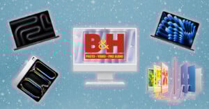 A white desktop computer with a B&H logo on the screen is centered on a blue background with snowflakes. Surrounded are various Apple devices: two laptops, a tablet, and colorful desktop computers.
