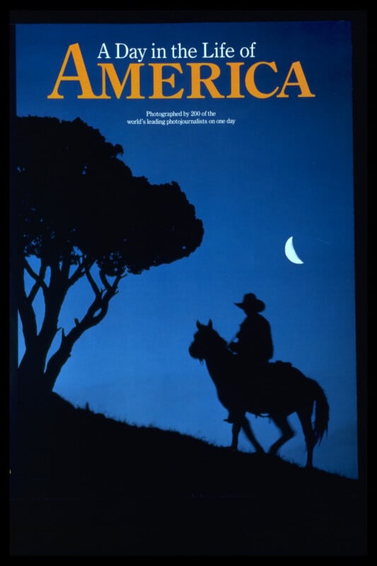 A cowboy on horseback is silhouetted against a deep blue sky with a crescent moon, next to a tree. The text reads: "A Day in the Life of America.