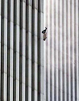 A person is falling headfirst against the vertical-striped facade of a tall building, with the structure dominating the background.