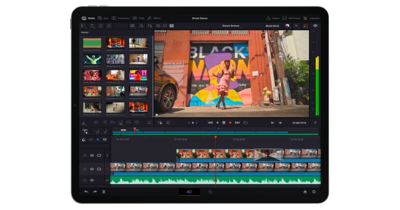 Interfaz del software de edición de video que se muestra en la pantalla de la tableta y que muestra videoclips, herramientas de edición y línea de tiempo. El avance del video principal muestra a una persona bailando frente a un colorido mural que dice "El negro es vibrante.