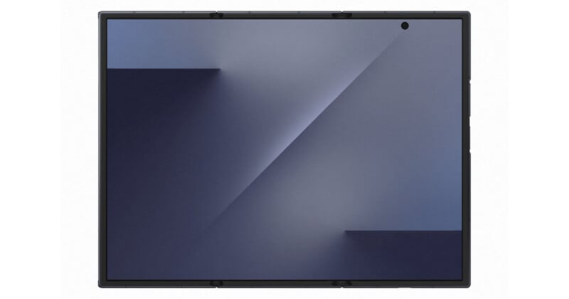 Tableta negra con una pantalla grande que muestra un papel tapiz geométrico azul y gris oscuro; Hay una pequeña cámara frontal en la esquina superior derecha del dispositivo.