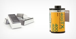 A group of silver bars stacked on the left and a roll of black and white 400 ISO photographic film on the right, both on a plain white background.