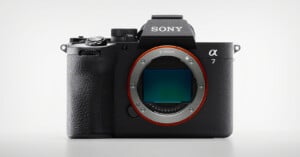 A Sony Alpha 7 mirrorless digital camera body with no lens attached, showing the large E-mount and image sensor on the front against a plain light background.