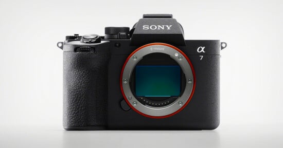 A Sony Alpha 7 mirrorless digital camera body with no lens attached, showing the large E-mount and image sensor on the front against a plain light background.