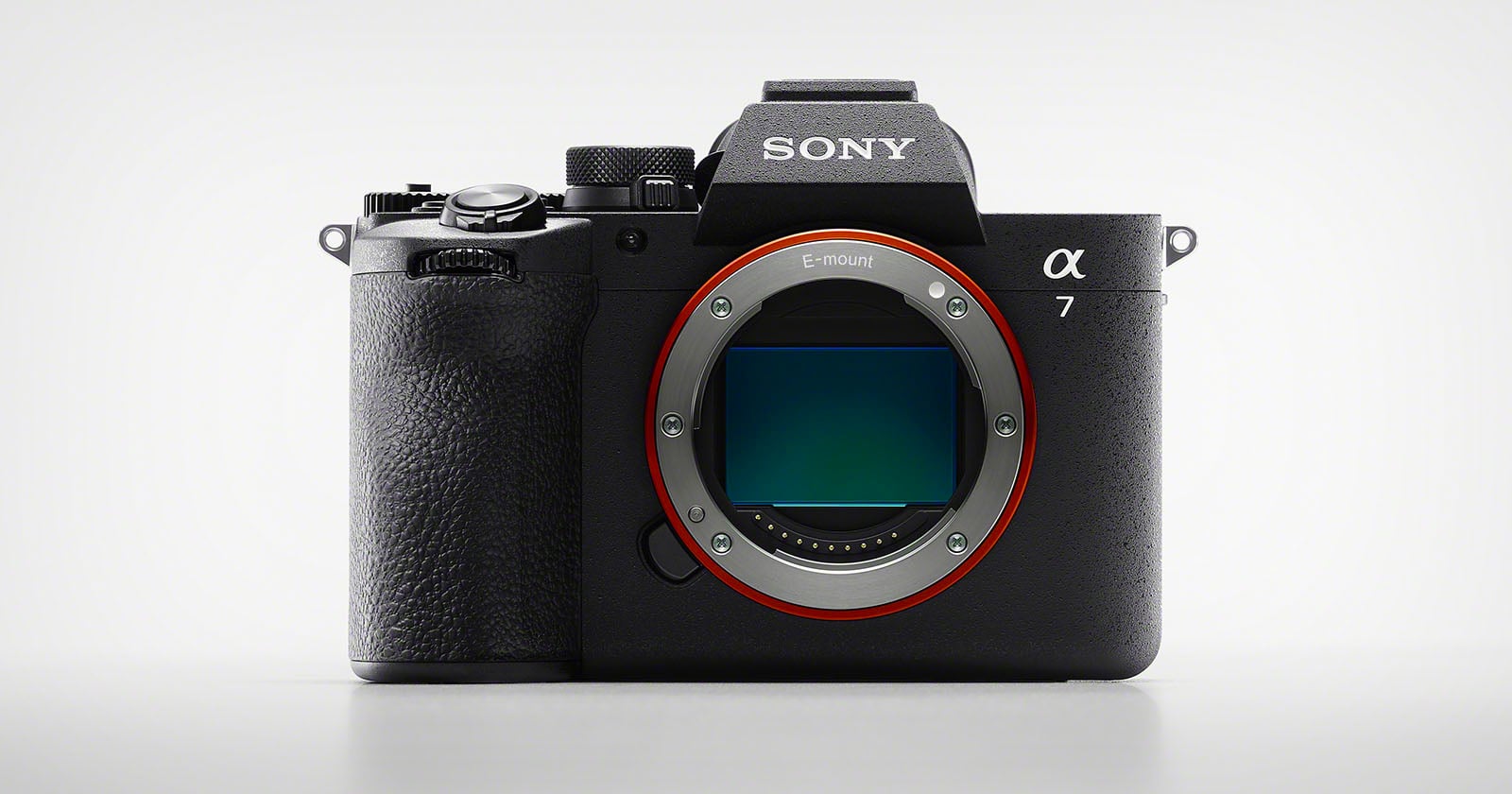 A Sony Alpha 7 mirrorless digital camera body is shown facing forward on a plain white background, with the lens removed to reveal the camera's image sensor.