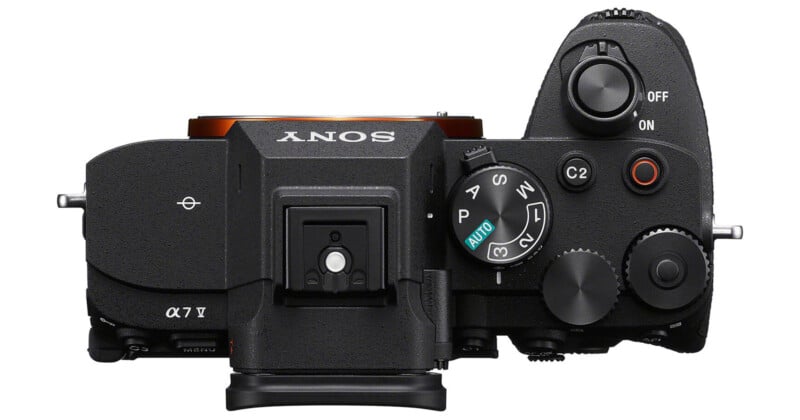 Top view of a Sony Alpha 7 IV mirrorless camera, showing the mode dial, control buttons, and the camera’s electronic viewfinder.