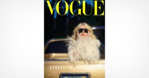 A person wearing black sunglasses and a white, feathered outfit stands in front of a gold car. The image is the cover of Vogue Portugal magazine, with large yellow text at the top and additional headlines below.