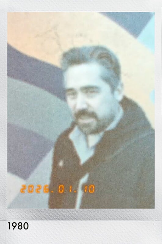A slightly blurry, retro-style photo of a man with gray hair and a beard standing in front of a colorful, wavy mural. The date "2026.01.10" is overlaid in orange digital text. The number "1980" appears below.