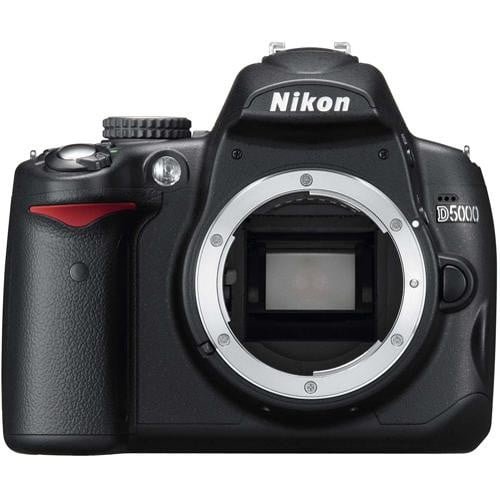 A black Nikon D5000 DSLR camera body with no lens attached, showing the lens mount and mirror inside. The brand name "Nikon" is visible above the lens mount.