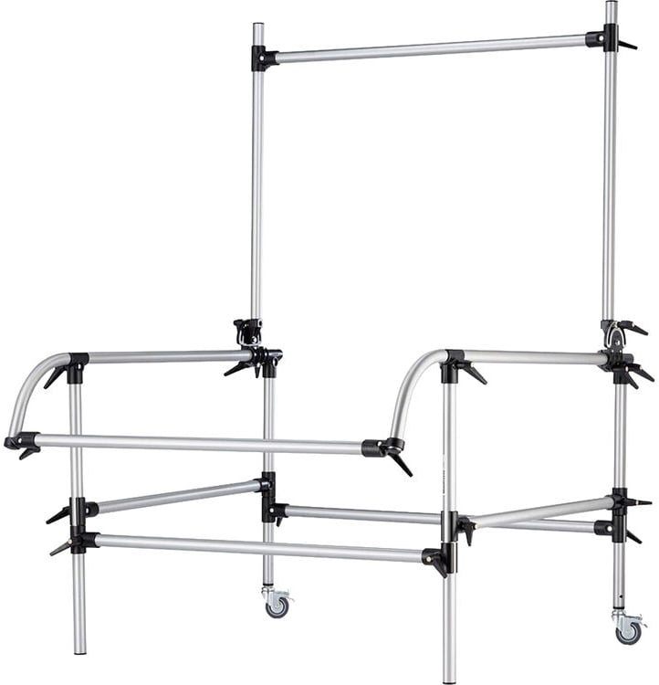 A metal frame structure with four wheels and multiple adjustable clamps and bars, resembling a hospital bed rail or a support frame for medical or industrial use.