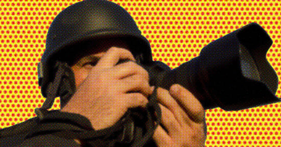 A person wearing a helmet holds a camera with a large lens, aiming to take a photo. The background features a bright yellow and red dot pattern, giving the image a pop art effect.