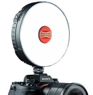 A round Rotolight LED ring light is mounted on top of a Sony camera, positioned above the camera lens, with the Rotolight logo visible in the center of the light.