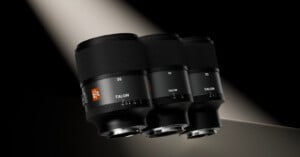 Three black camera lenses labeled 35, 50, and 75 with the brand name "Talon" are displayed side by side under a dramatic beam of light against a dark background.