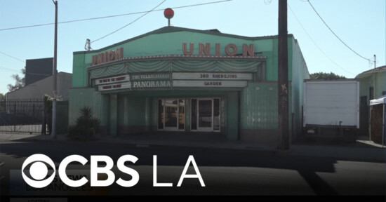 A vintage green building with a marquee reading “UNION” and advertising “Panorama.” The entrance has glass doors and decorative panels. The image also includes a CBS LA logo at the bottom.