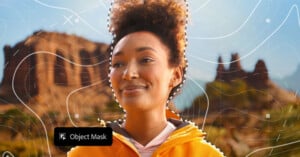 A woman smiling with a curly hair.